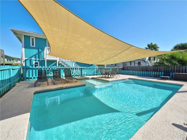 view of swimming pool with a patio