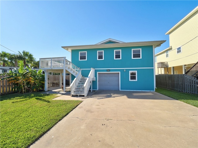 back of property featuring a lawn and a garage