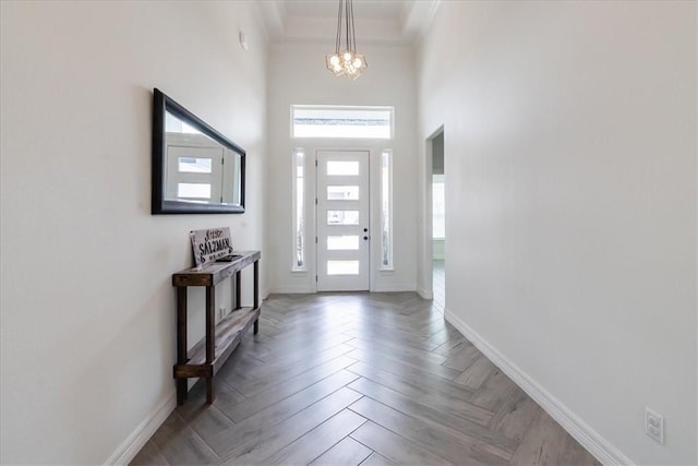 7910 Parham Dr, Corpus Christi, TX 78414 - foyer featuring a chandelier, a towering ceiling, and crown molding