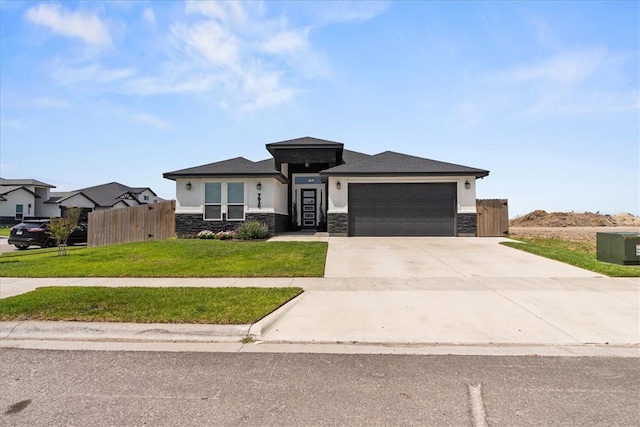 7910 Parham Dr, Corpus Christi, TX 78414 - prairie-style house featuring stone siding, a garage, stucco siding, driveway, and a gate
