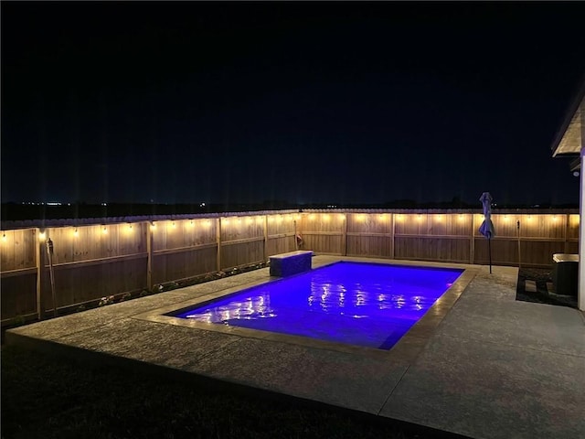 7910 Parham Dr, Corpus Christi, TX 78414 - pool at night with a fenced backyard and a patio