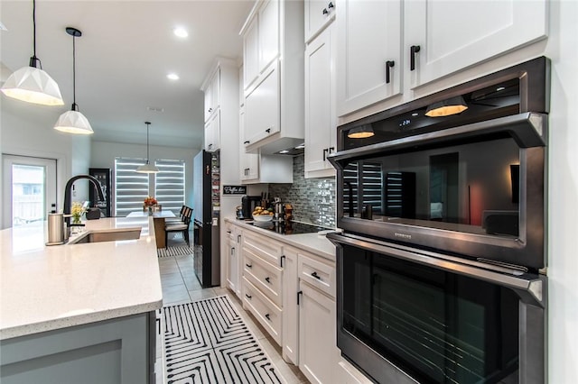 6730 Effat Dr, Corpus Christi, TX 78414 - kitchen with black appliances, decorative backsplash, white cabinetry, decorative light fixtures, and recessed lighting