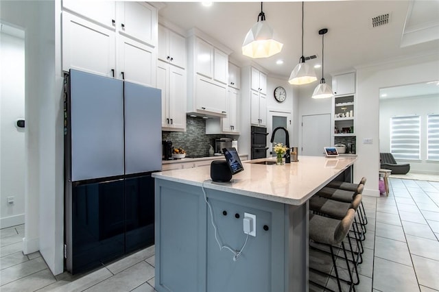 6730 Effat Dr, Corpus Christi, TX 78414 - kitchen with fridge, decorative backsplash, white cabinets, light tile patterned floors, and recessed lighting