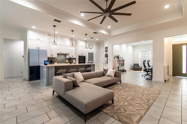 6730 Effat Dr, Corpus Christi, TX 78414 - living area with crown molding, ceiling fan, a raised ceiling, recessed lighting, and light tile patterned floors