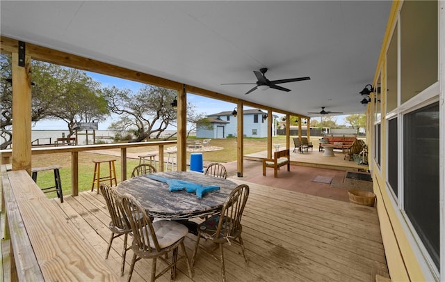 wooden deck with a water view and a yard