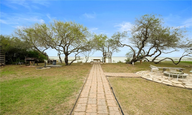 view of yard featuring a patio and an outdoor fire pit