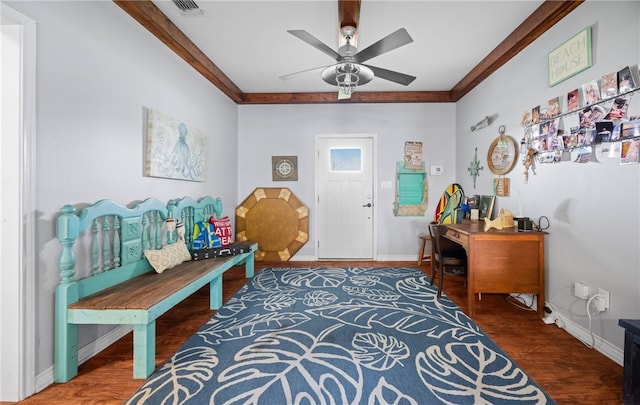 foyer with ceiling fan, crown molding, and dark hardwood / wood-style floors