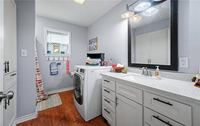 laundry room with cabinets, dark hardwood / wood-style flooring, and sink