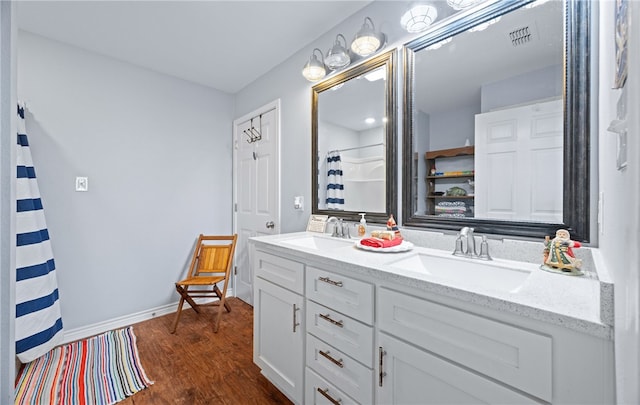 bathroom featuring vanity, hardwood / wood-style flooring, and walk in shower