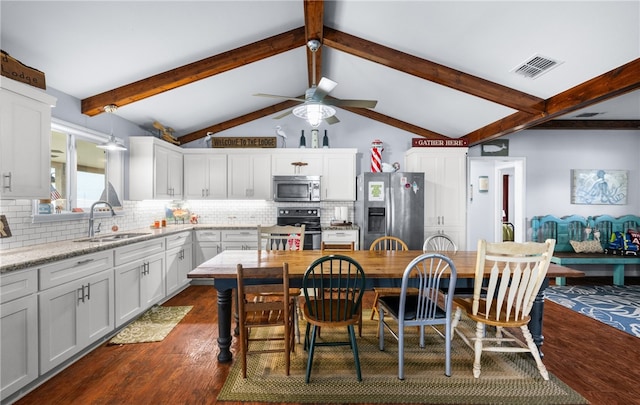 kitchen featuring white cabinets, decorative backsplash, sink, and stainless steel appliances