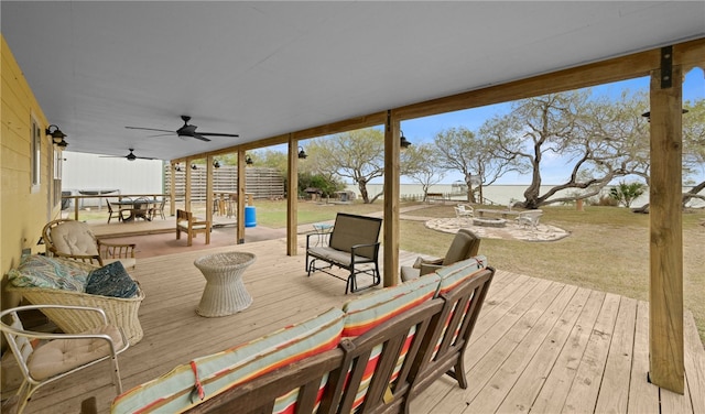 wooden terrace featuring ceiling fan and an outdoor living space