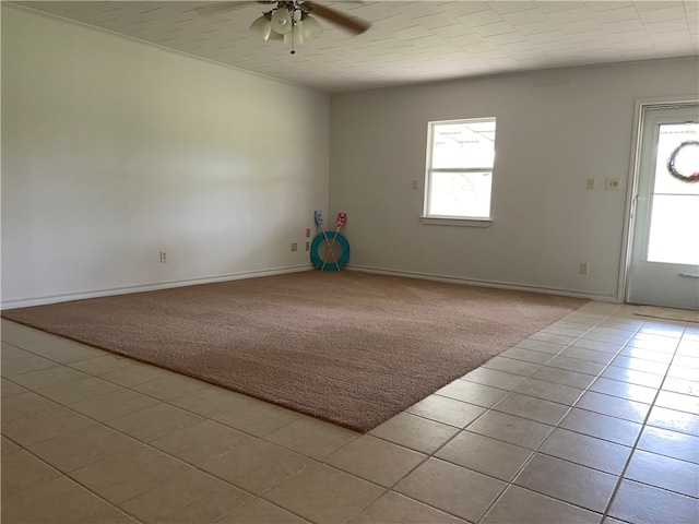 carpeted empty room featuring ceiling fan