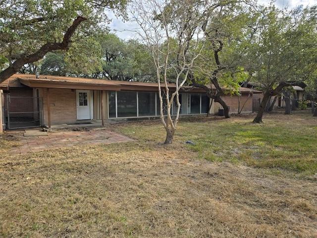 rear view of property with a lawn