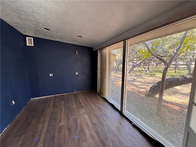 empty room with dark hardwood / wood-style flooring