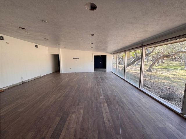 unfurnished living room with dark hardwood / wood-style flooring