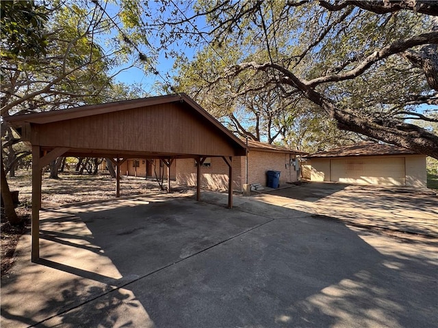 exterior space featuring a garage and an outbuilding