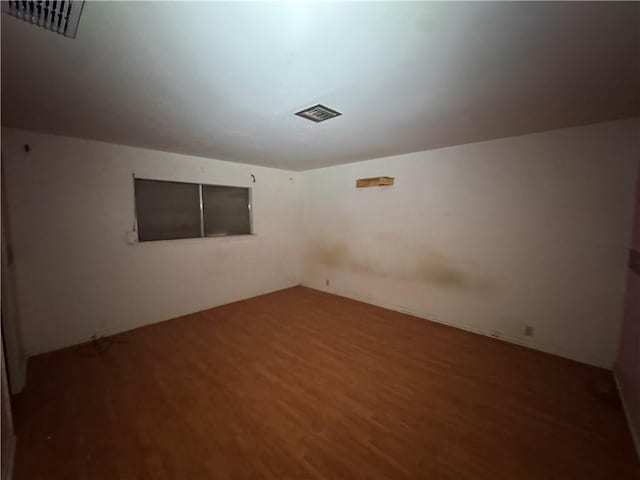 unfurnished room with hardwood / wood-style flooring