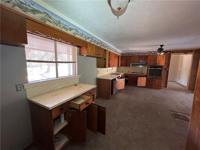 kitchen with sink, ceiling fan, and appliances with stainless steel finishes