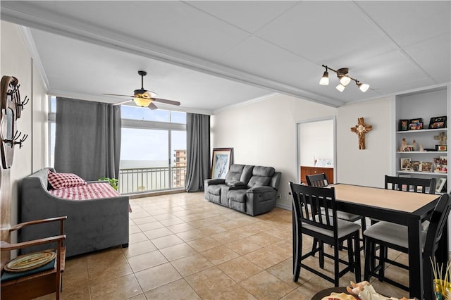 tiled dining area with ornamental molding, expansive windows, and ceiling fan