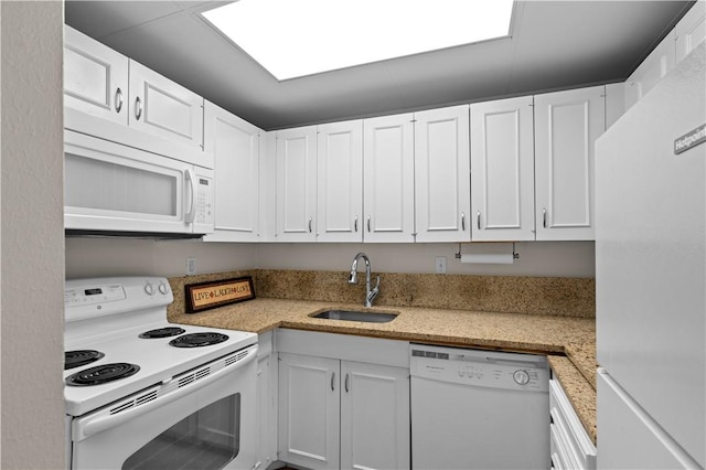 kitchen featuring white cabinetry, sink, and white appliances