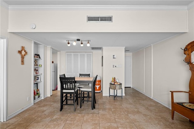 tiled dining area featuring ornamental molding