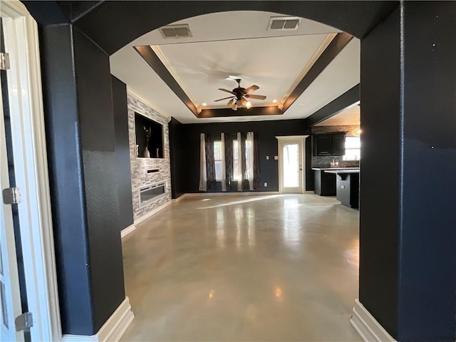 interior space with arched walkways, visible vents, and a raised ceiling