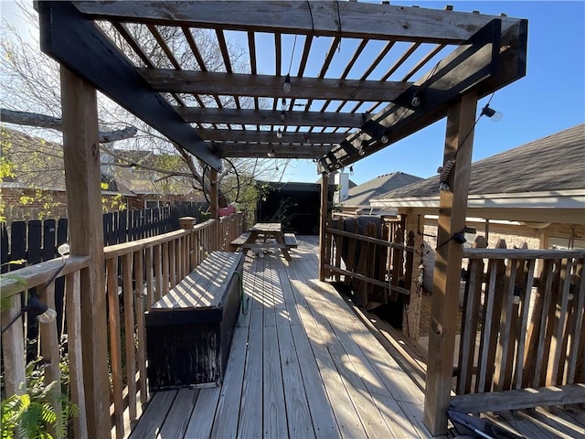 wooden terrace featuring fence