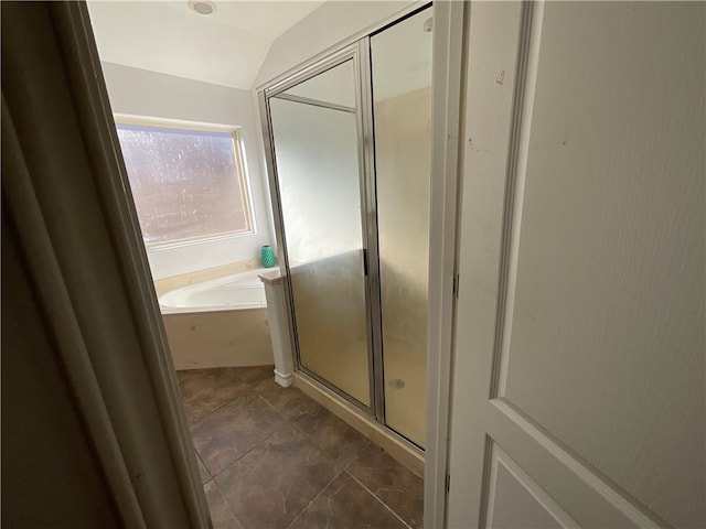 bathroom with a shower stall, a garden tub, and vaulted ceiling