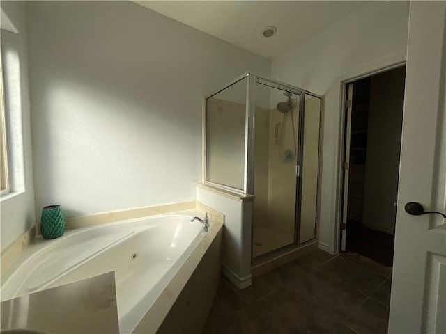 full bathroom with tile patterned floors, a tub with jets, and a shower stall