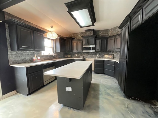 kitchen with a sink, decorative backsplash, a kitchen island, and stainless steel appliances