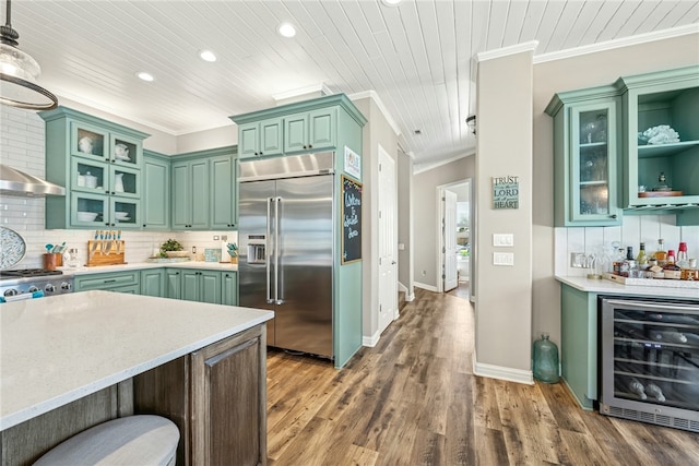 6 Sea Shell Shores Dr, Rockport, TX 78382 - kitchen featuring green cabinets, beverage cooler, and built in fridge