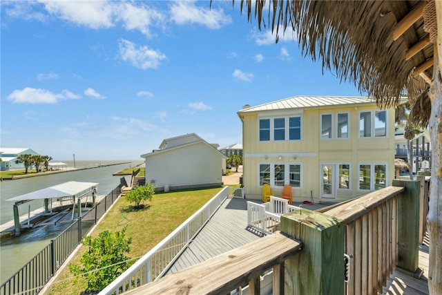 6 Sea Shell Shores Dr, Rockport, TX 78382 - exterior space featuring fence, a water view, a standing seam roof, a lawn, and metal roof