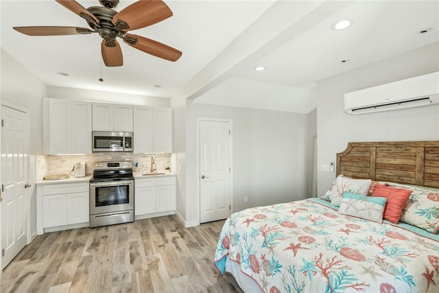 6 Sea Shell Shores Dr, Rockport, TX 78382 - bedroom with recessed lighting, an AC wall unit, a sink, light wood-style flooring, and ceiling fan