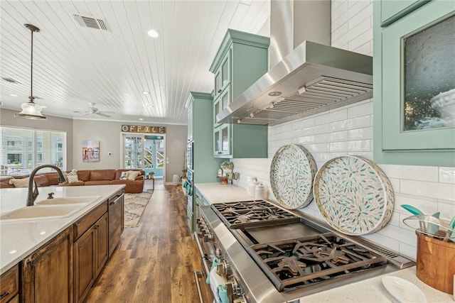 6 Sea Shell Shores Dr, Rockport, TX 78382 - kitchen featuring cooktop, green cabinetry, visible vents, a sink, and wall chimney exhaust hood