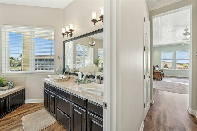 6 Sea Shell Shores Dr, Rockport, TX 78382 - bathroom with double vanity, wood finished floors, baseboards, and a sink