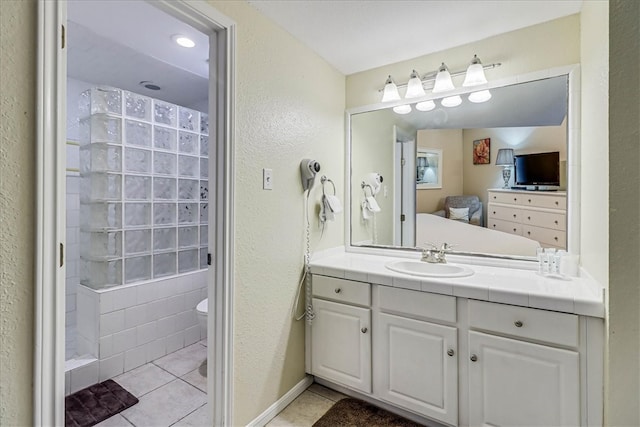 bathroom featuring vanity, tile patterned floors, and toilet