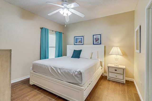 bedroom with ceiling fan and light wood-type flooring