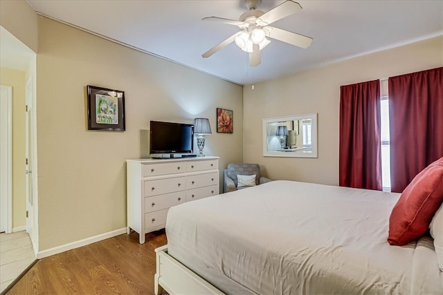 bedroom with hardwood / wood-style floors and ceiling fan