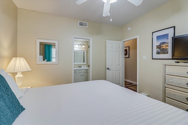 bedroom featuring sink, ceiling fan, and ensuite bath