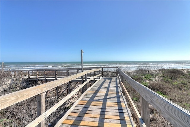 surrounding community featuring a view of the beach and a water view