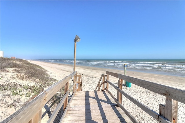 view of home's community featuring a beach view and a water view