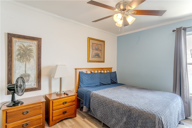 bedroom featuring ceiling fan, light wood-type flooring, and ornamental molding