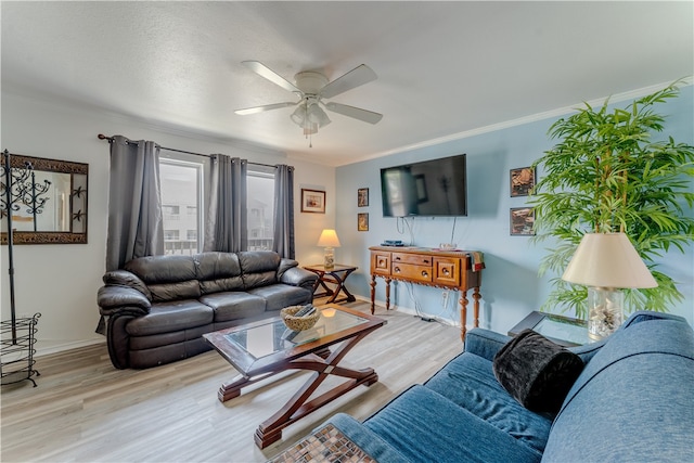 living room featuring ceiling fan, wood-type flooring, and ornamental molding