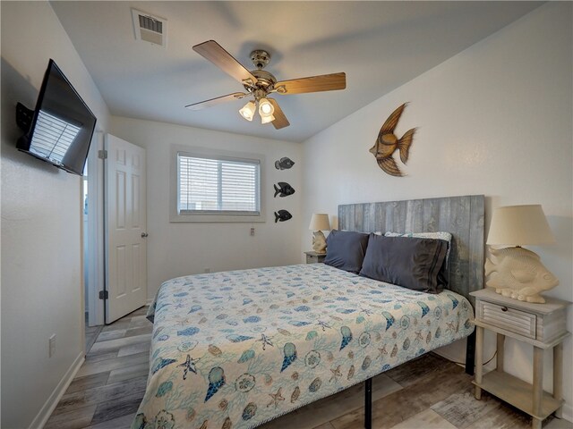 bedroom featuring hardwood / wood-style flooring and ceiling fan