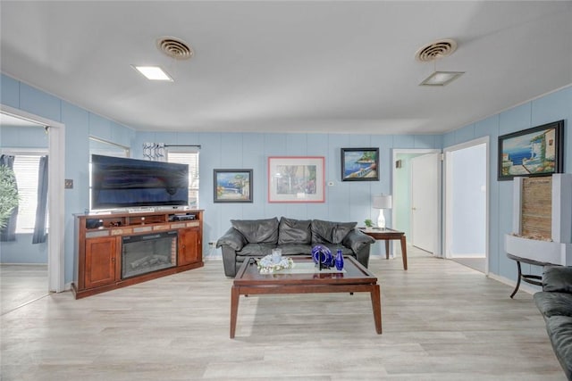 1038 Herndon St, Corpus Christi, TX 78411 - living room with plenty of natural light, light wood-style flooring, and a decorative wall