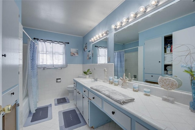 1038 Herndon St, Corpus Christi, TX 78411 - bathroom featuring vanity, shower / tub combo, tile walls, a wainscoted wall, and tile patterned flooring