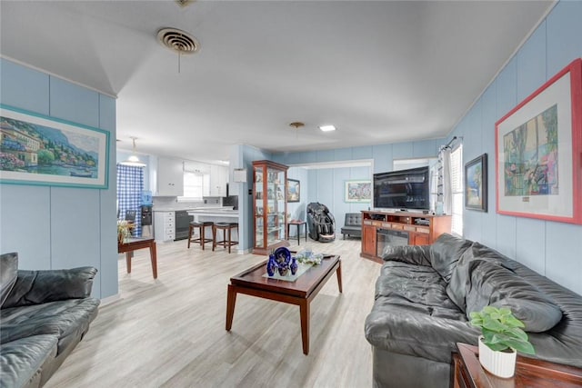 1038 Herndon St, Corpus Christi, TX 78411 - living area with light wood finished floors and a decorative wall