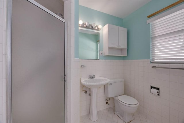 1038 Herndon St, Corpus Christi, TX 78411 - full bath with tile walls, a stall shower, tile patterned floors, and a wainscoted wall