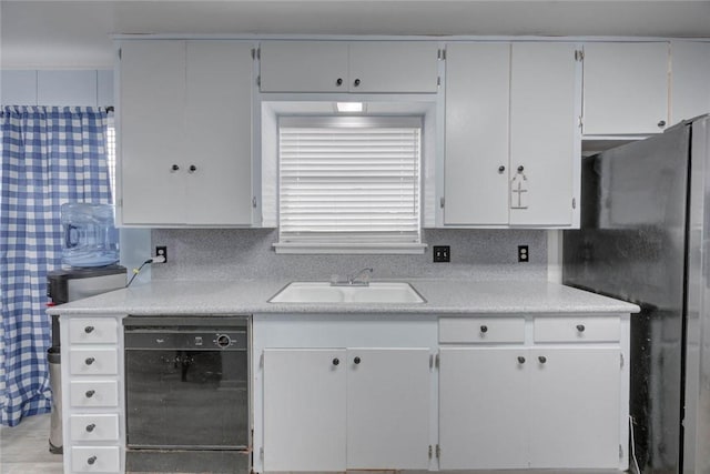 1038 Herndon St, Corpus Christi, TX 78411 - kitchen featuring dishwasher, light countertops, white cabinetry, and freestanding refrigerator
