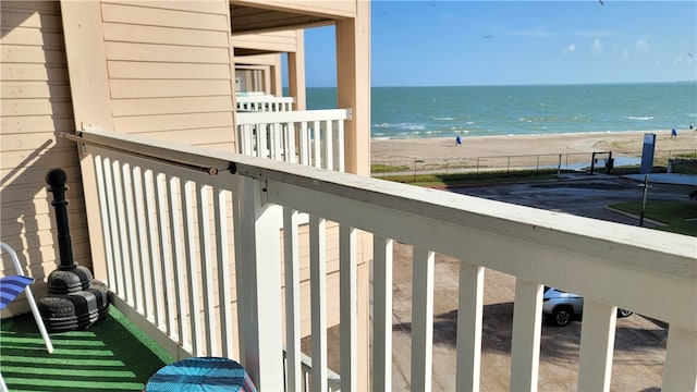 balcony with a beach view and a water view